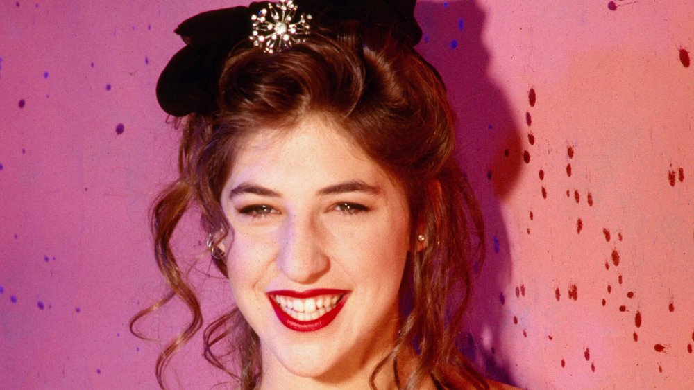 Mayim Bialik as a young woman with a bow on her head