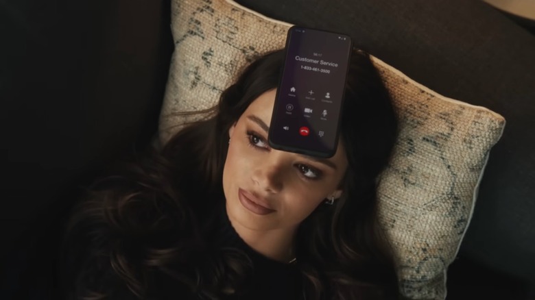 Keleigh Sperry with a phone on her forehead in a commercial