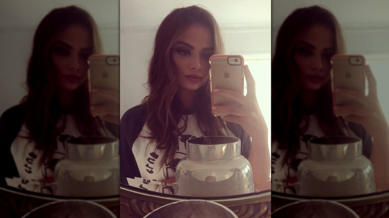 Keleigh Sperry taking selfie in mirror with iPhone