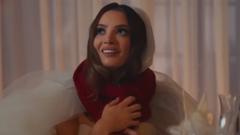 Keleigh Sperry in a red scarf and wedding dress