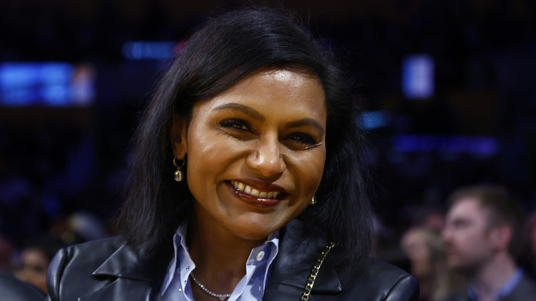 Mindy Kaling smiling in leather jacket 