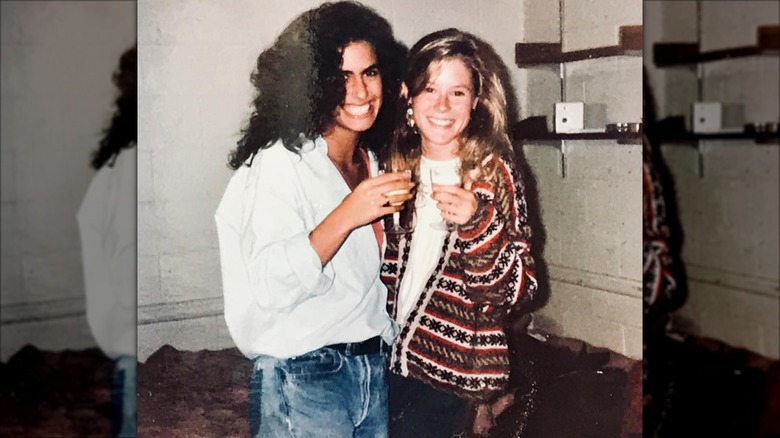 Young Julie Bowen and a friend posing at a party