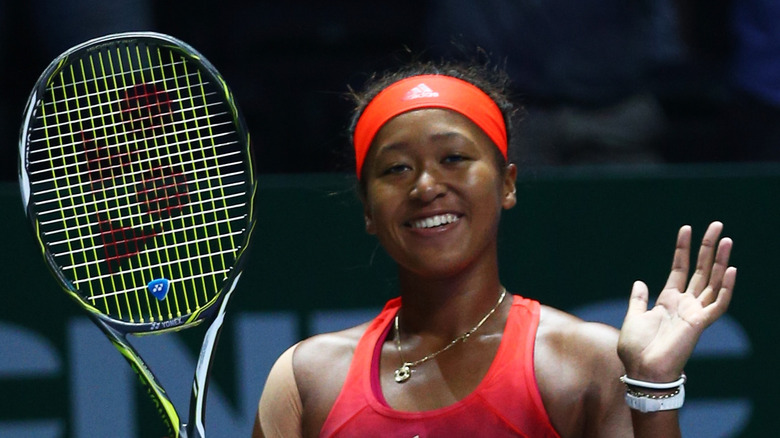 Naomi Osaka with her racket in 2015, smiling