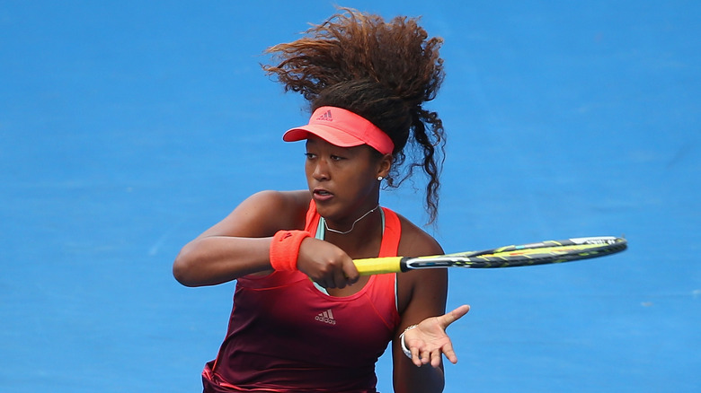 Naomi Osaka hitting a forehand in 2016