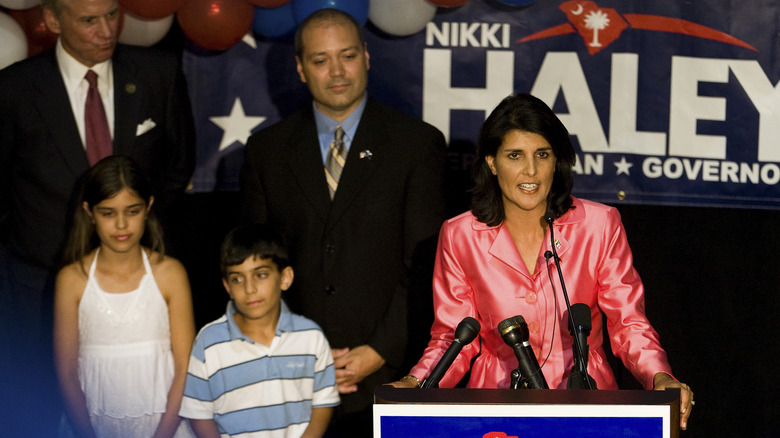 Nikki Haley speaking at a podium with her family