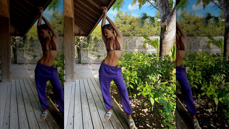 Nina Agdal stretching in bikini top and pants