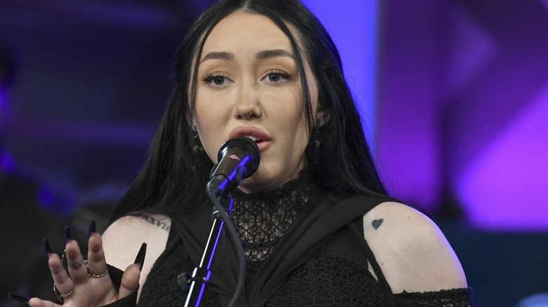 Noah Cyrus at a microphone