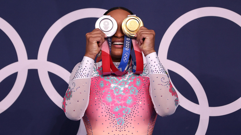 Rebeca Andrade poses with her silver and gold medals 