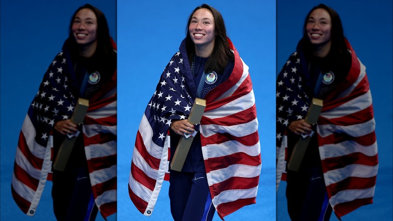 Torri Huske smiling with American flag 