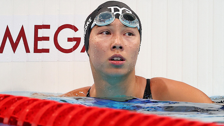 Torri Huske swims in cap and goggles 