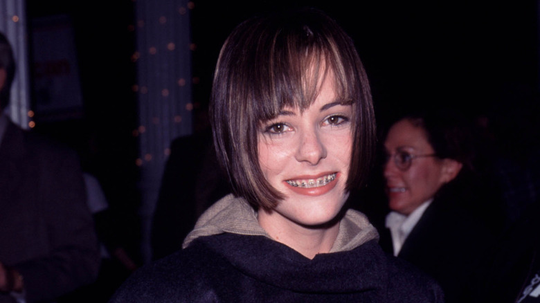 Parker Posey showing mouthful of braces at a celebrity pet fashion show