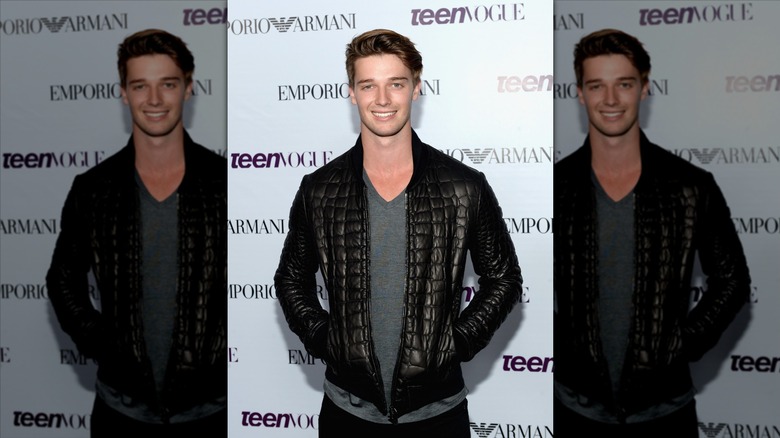 Patrick Schwarzenegger in a leather jacket on an Armani and Teen Vogue step and repeat