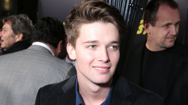 Patrick Schwarzenegger walking through a crowd