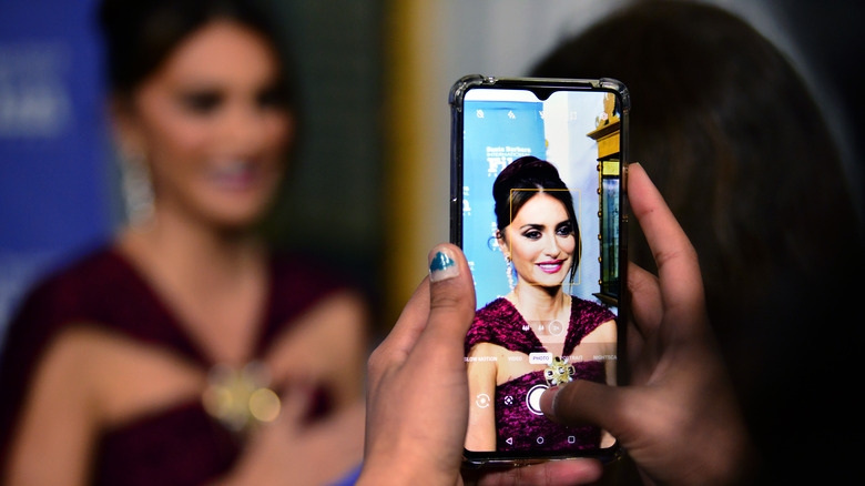 Penelope Cruz getting photo taken on phone