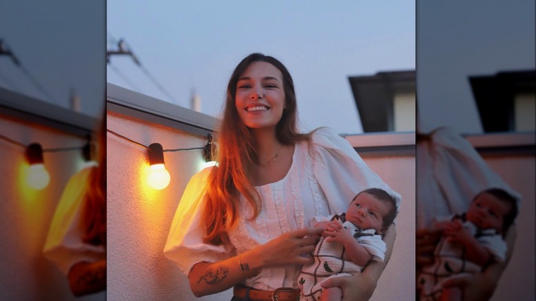 Marzia holding her son