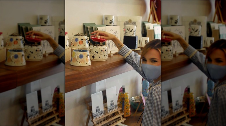 Marzia reaching for ceramics display