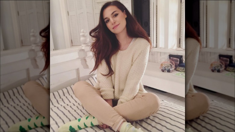 Marzia Kjellberg sitting on bed