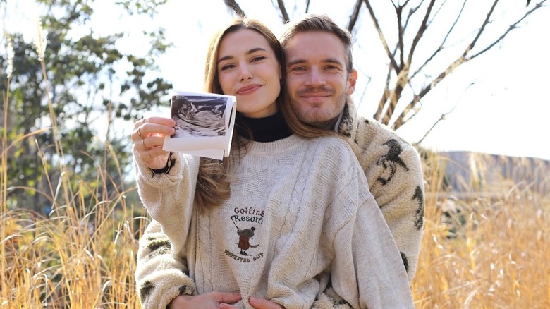 Marzia and Felix Kjellberg smiling with sonogram image 