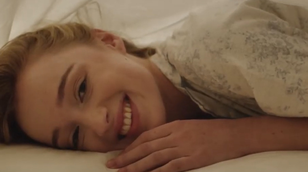 Phoebe Dynevor laying down, smiling