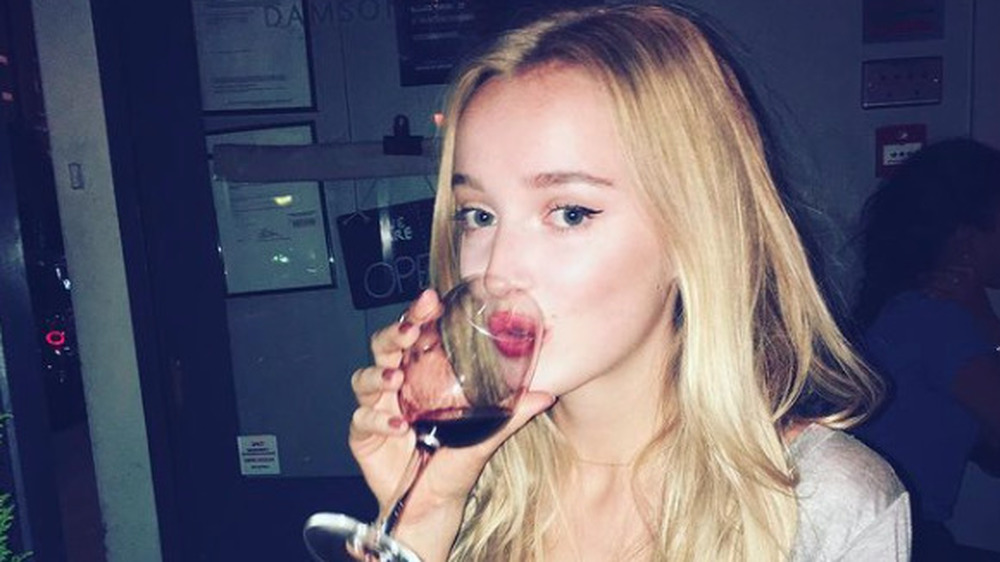 Phoebe Dynevor drinking a glass of wine