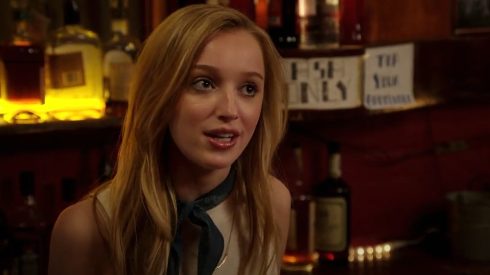 Phoebe Dynevor inside of a bar