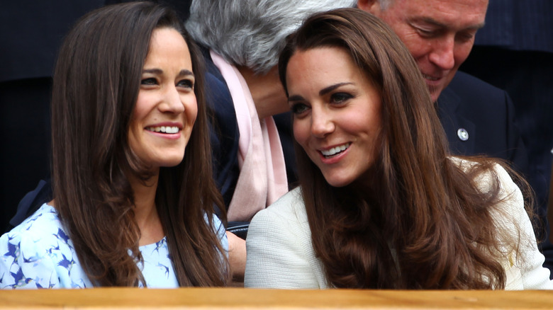 Pippa and Kate Middleton talking