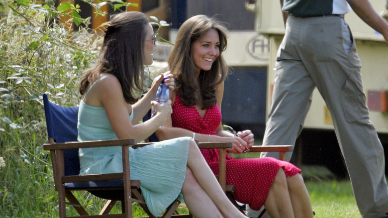 Pippa and Kate Middleton talking