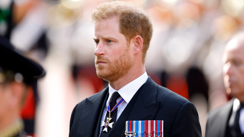 Prince Harry standing with Prince Charles