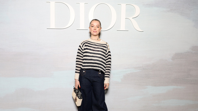 Princess Alexandra of Hanover posing in front of Dior sign