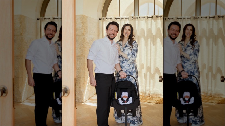 Princess Rajwa and Prince Hussein smile at their baby