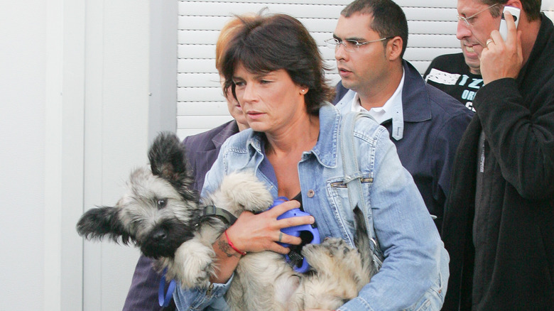 Princess Stephanie holding a dog