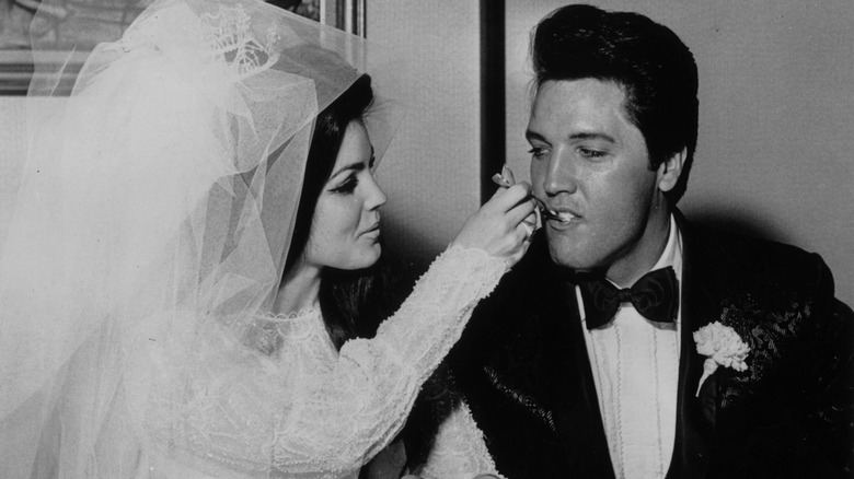 Priscilla Presley feeding Elvis cake on their wedding day