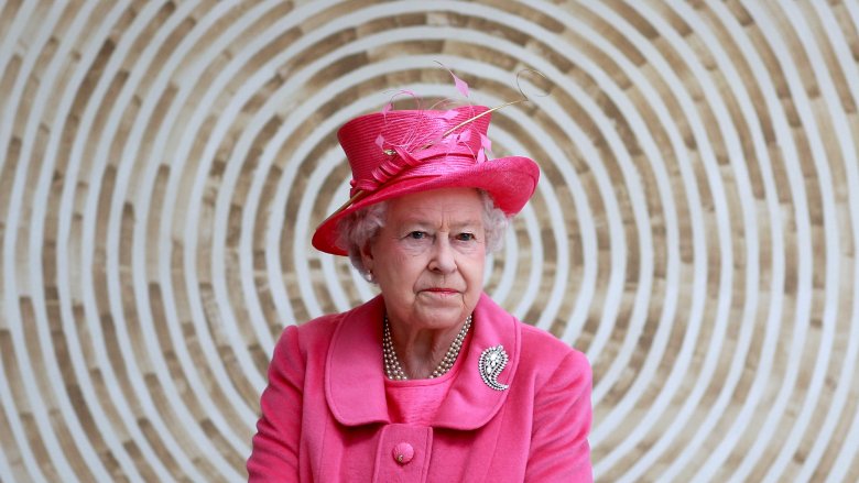 Queen Elizabeth II wearing neon pink outfit and hat