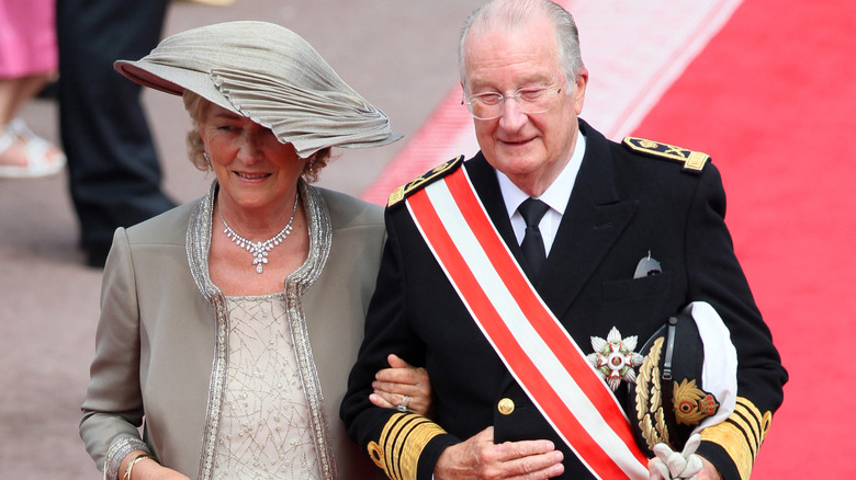 Queen Paola and King Albert linking arms