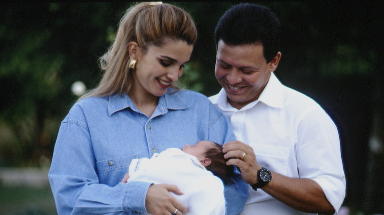 Queen Rania and King Abdullah holding baby