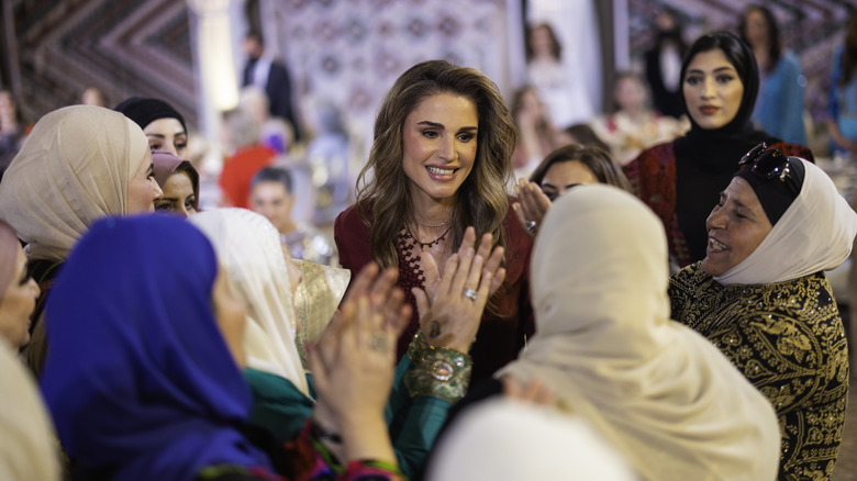 Queen Rania smiling with group of women