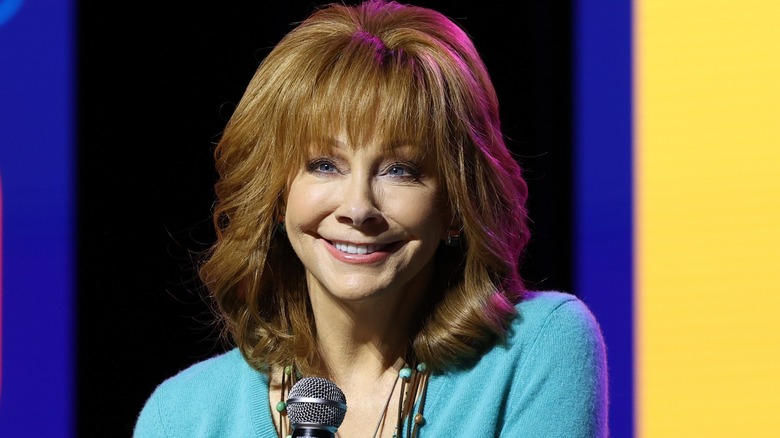 Reba McEntire smiling into microphone