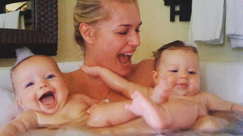 Rebecca Romijn holding twins