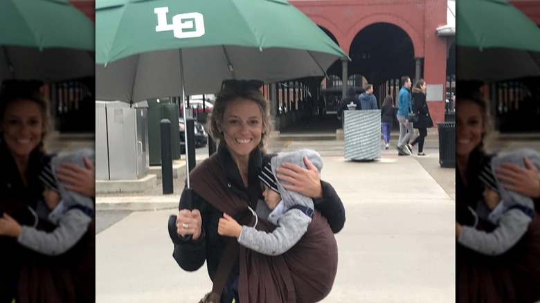 Nicole Curtis and her younger son under an umbrella