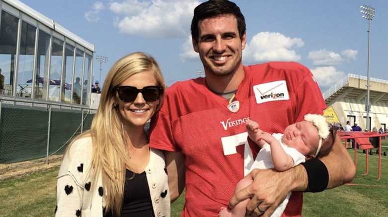 Samantha Ponder, Christian Ponder, and Scout on a football field