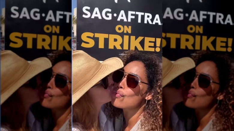 Sarah Rafferty kisses Gina Torres at picket