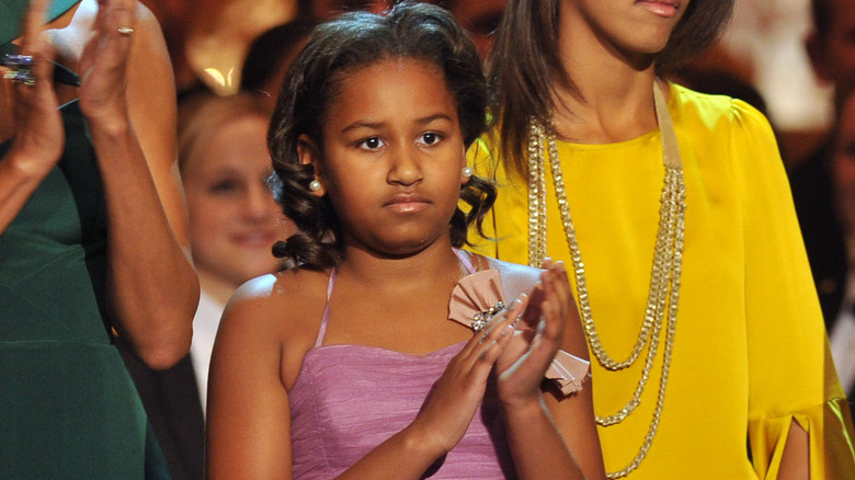 Sasha Obama as a child applauding