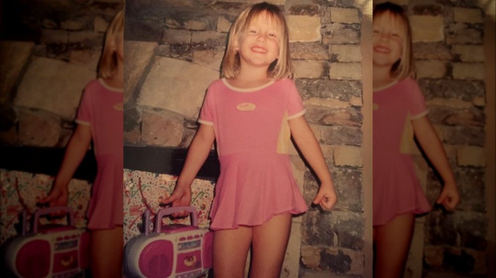 Savannah Chrisley as a girl wearing a pink dress