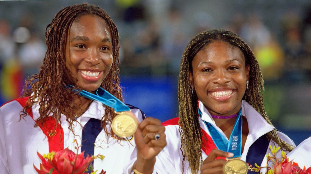 Venus and Serena Williams with medals in 2000