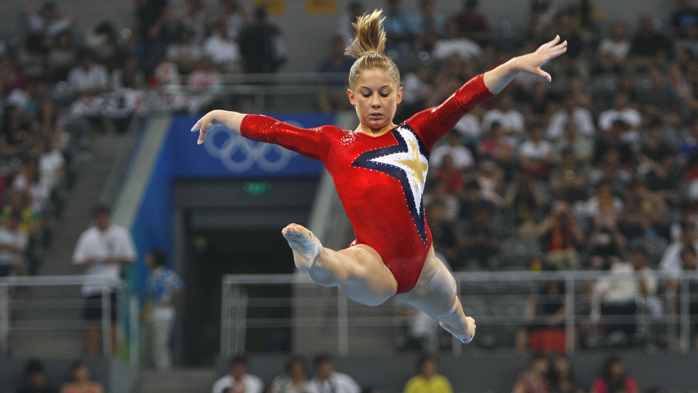 Shawn Johnson performing gymnastics stunt