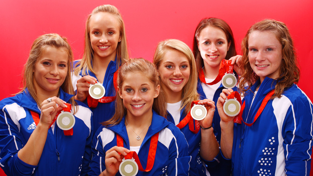 Shawn Johnson and her team posing with Olympic medals
