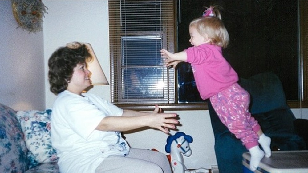 Young Shawn Johnson jumping into her mom's arms