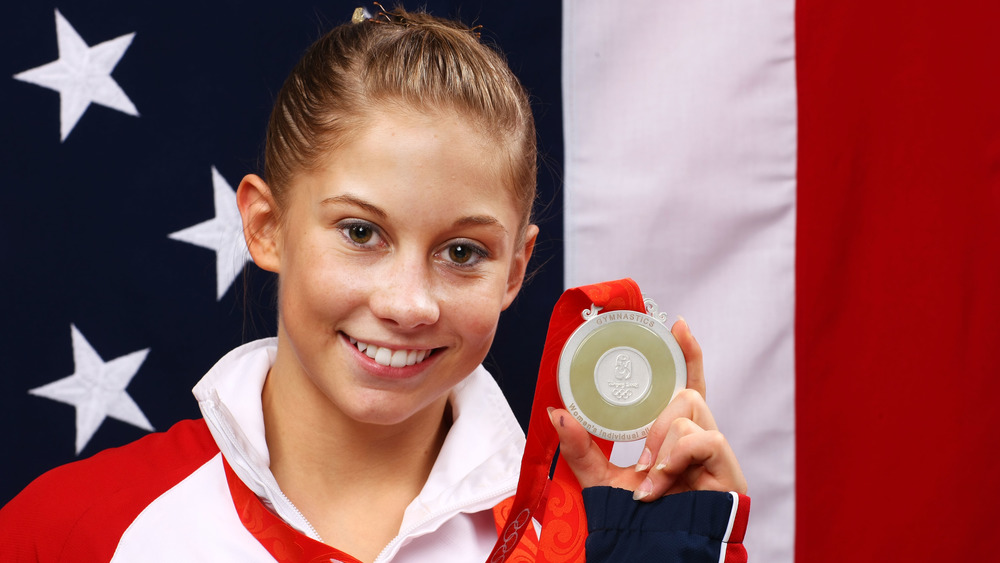 Shawn Johnson holding up a medal