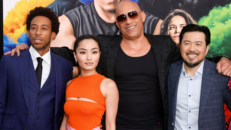 Anna Sawai, Ludacris, Vin Diesel, and Justin Lin smiling at the "F9" world premiere at TCL Chinese Theater