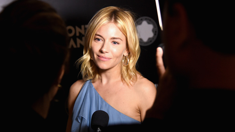 Sienna Miller giving an interview on the red carpet